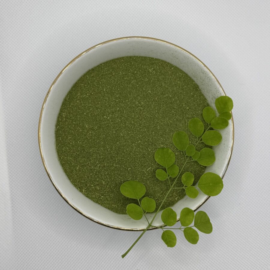 Bowl of green moringa leaf powder